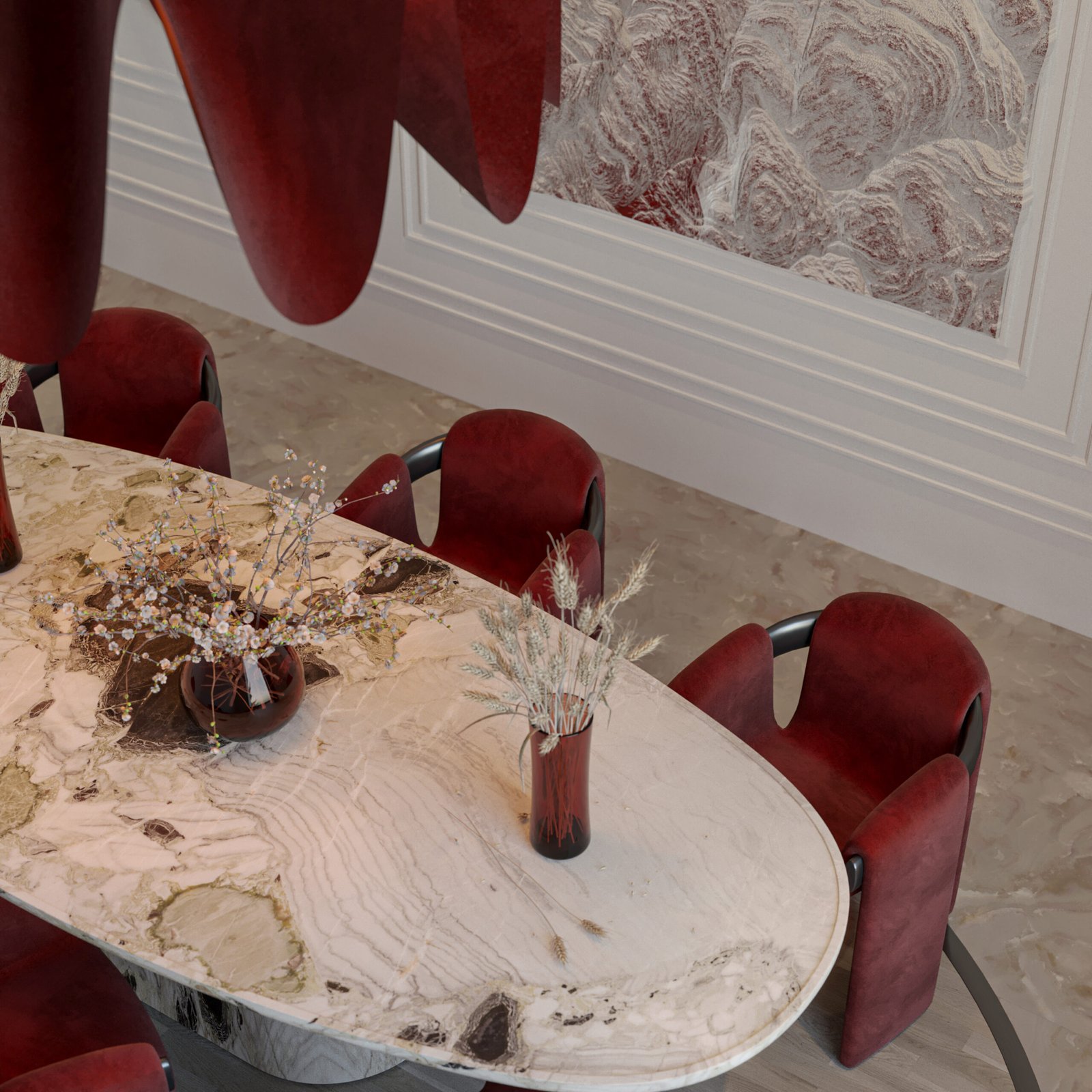  A contemporary dining room featuring a bold red sculptural chandelier, velvet chairs, and a marble table set against a textured wall panel.