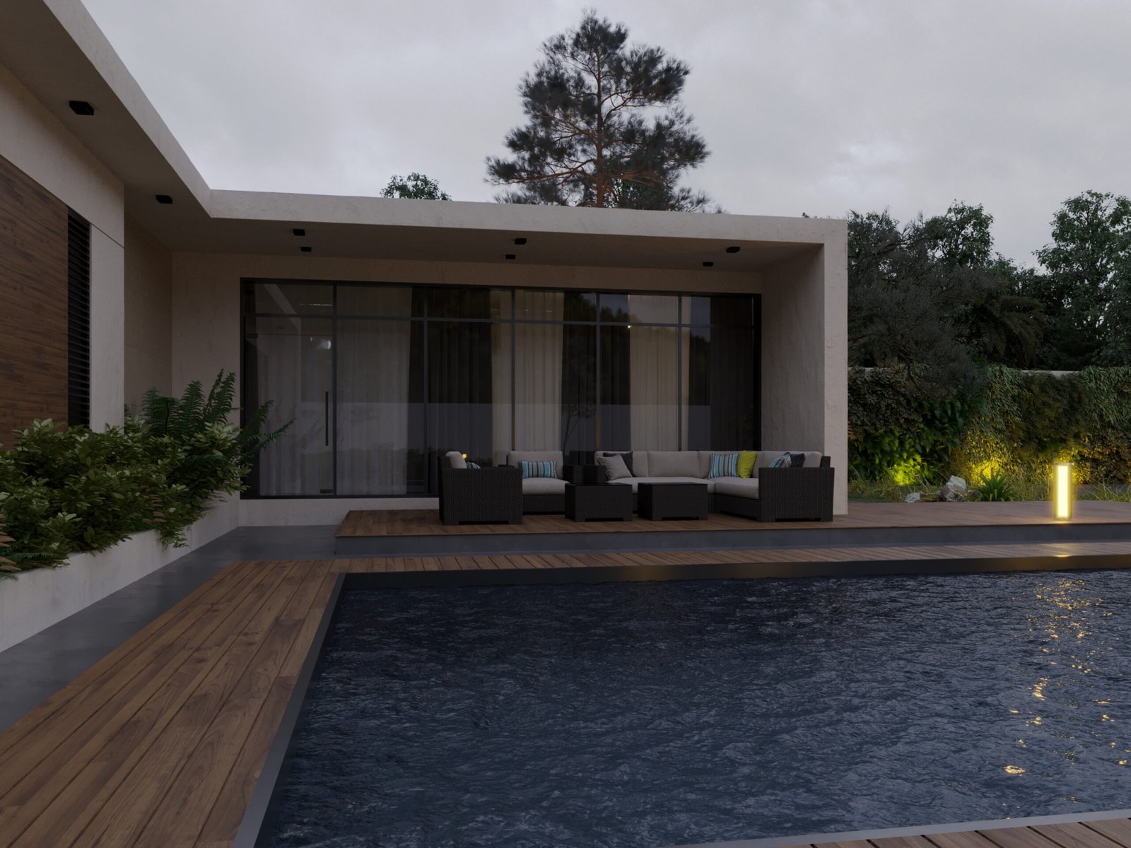 Outdoor seating area overlooking a pool with warm lighting and minimalist architecture