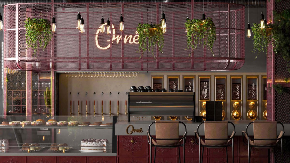 Modern café interior with red mesh structure, hanging plants, and coffee counter in Riyadh