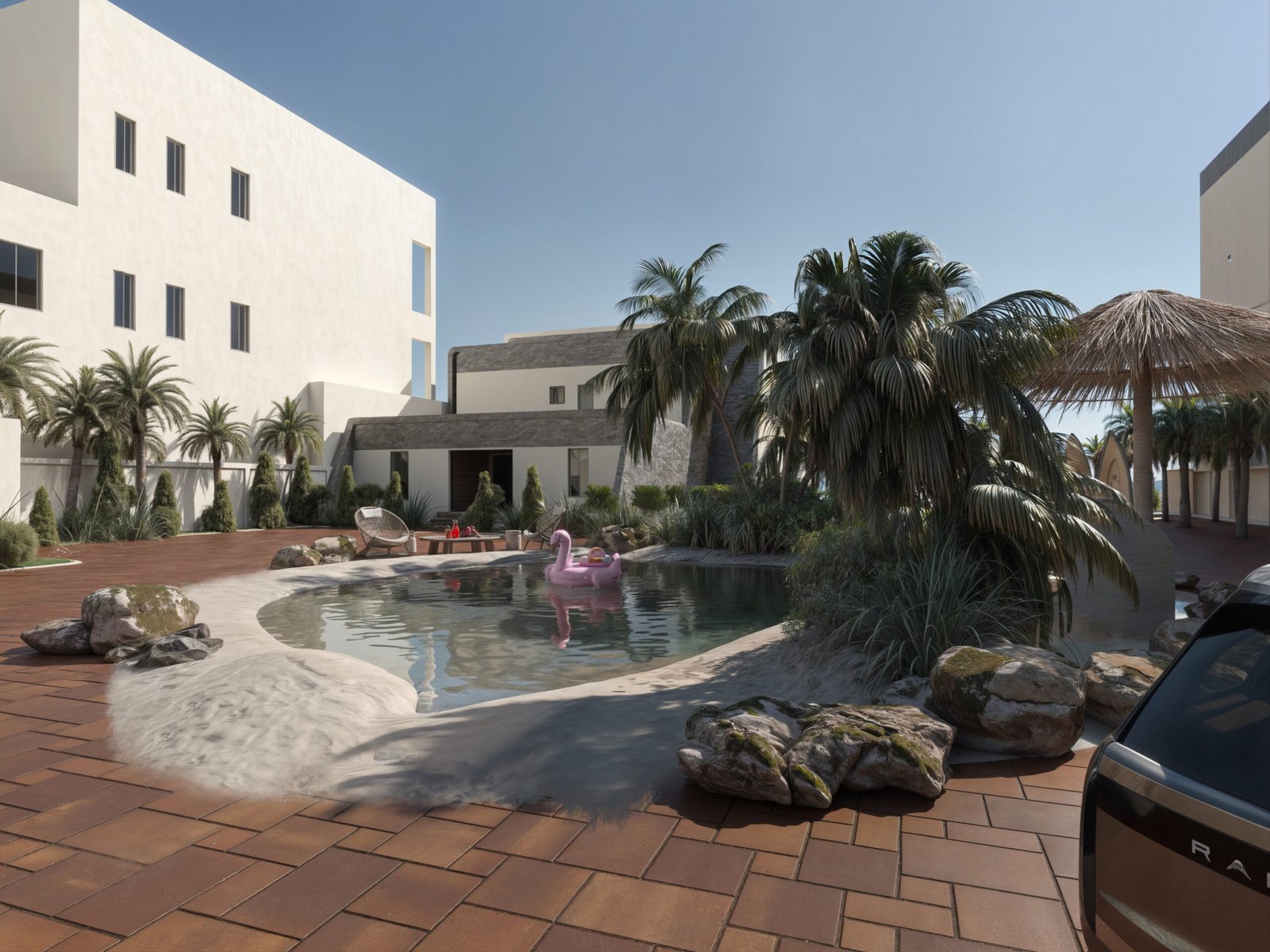 A lagoon-shaped pool surrounded by palm trees, natural rocks, and contemporary architecture creating a private beach atmosphere.